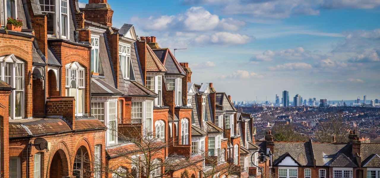 London, England - Typical brick houses and flats and panoramic view of london on a nice summer morning with blue sky and clouds taken from Muswell Hill